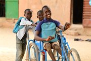 A child with a disability is playing with his friends.