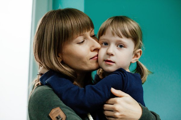 A mother is holding her child.